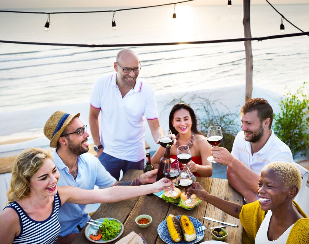 a group of people toasting wine glasses on a bench