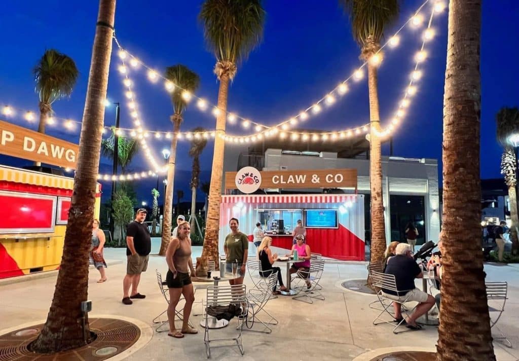 String lights hanging overhead at outdoor dining hall. 